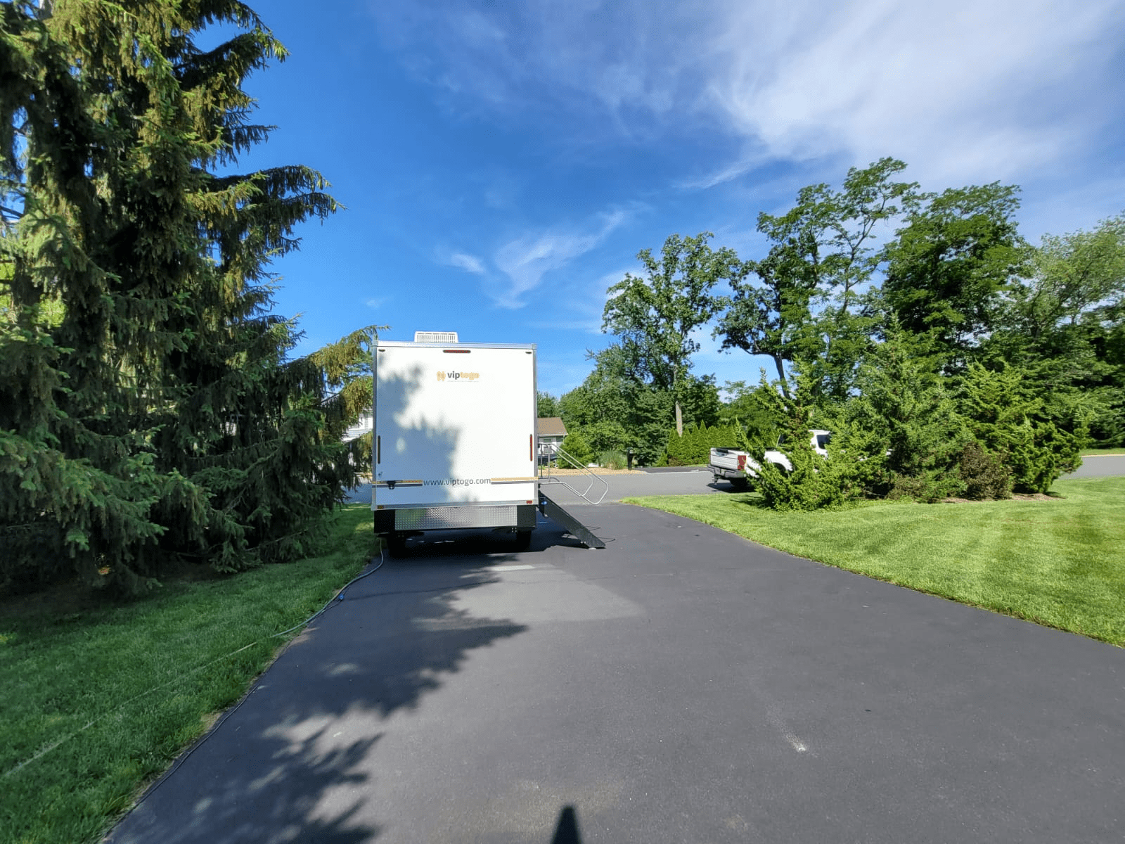 park restroom trailer amidst greenery